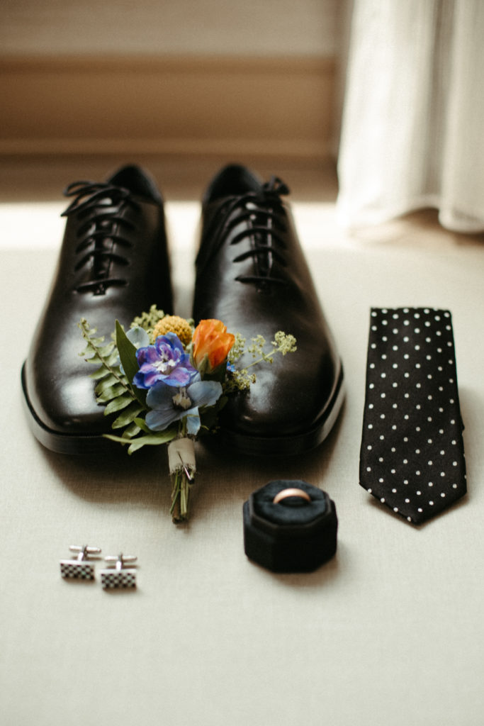 A groom's details laid out in a decorative fashion.
