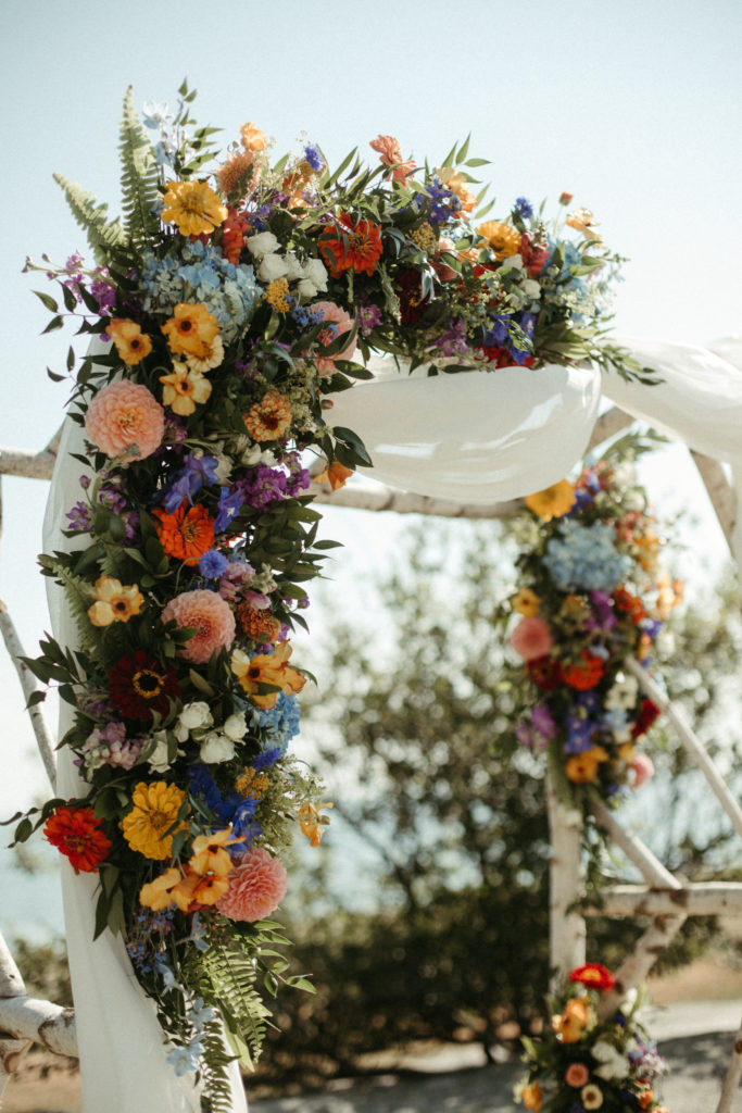 A wedding ceremony arch decorated with flowers.