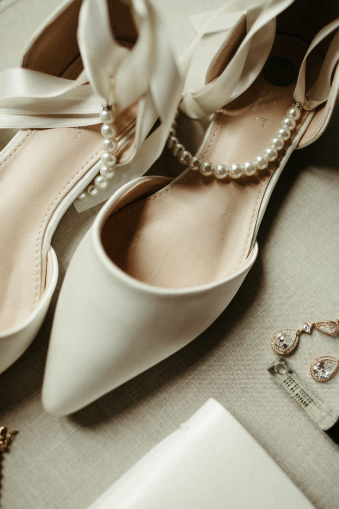 Bridal shoes close up with pearl details.