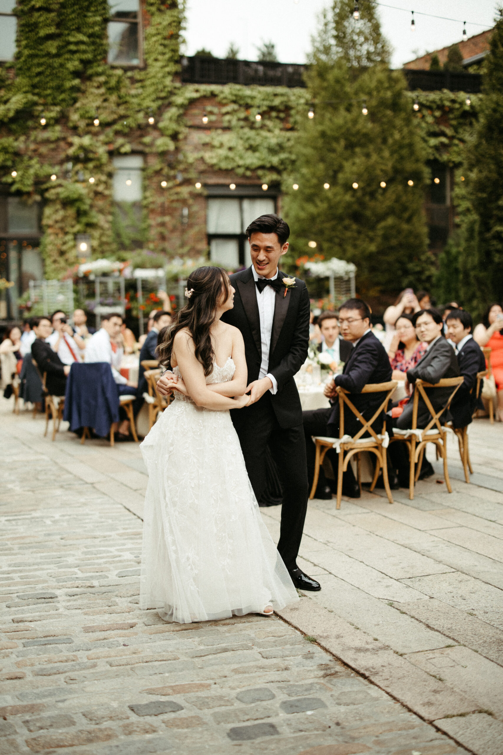 Twinkling lights witness the couple's choreographed first dance—a celebration of shared stories and pure joy at The Foundry LIC Wedding.