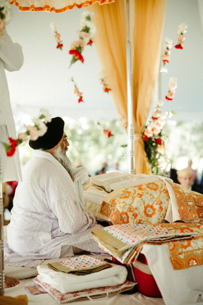 A close-up shot of the sacred Guru Granth Sahib, the focal point of the Laavan ceremony, symbolizing spiritual union.
