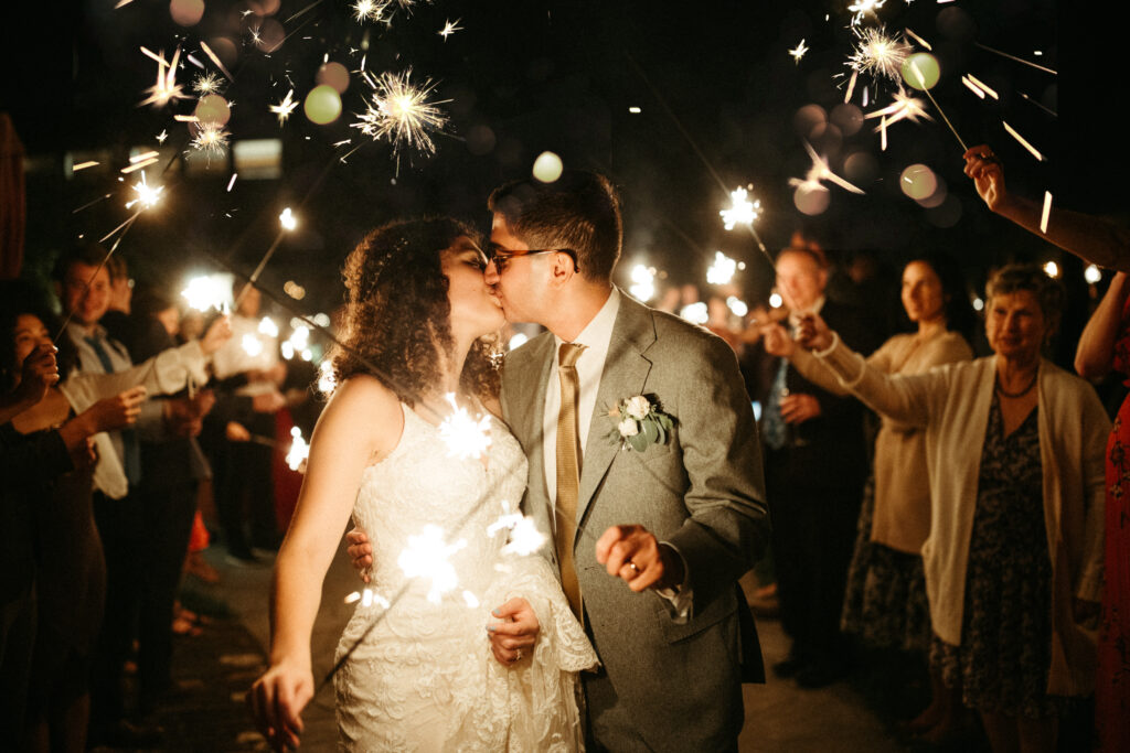 Sparkler Exit: A magical sparkler exit, casting a glow on the couple's love story as they bid farewell to their Red Maple Vineyard wedding.





