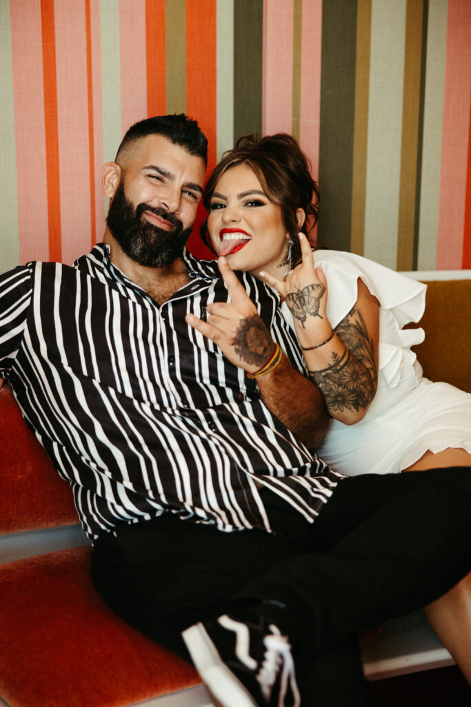 A candid moment of love and laughter captured at the TWA Hotel engagement shoot.