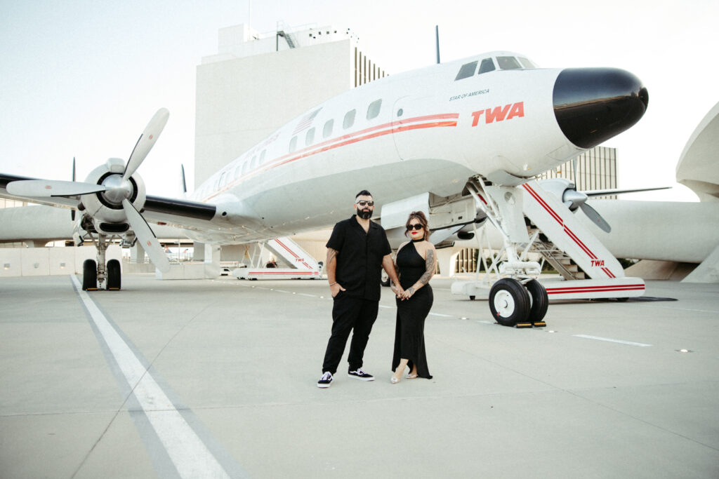 A stylish engagement session in front of the iconic TWA airplane at JFK Airport.