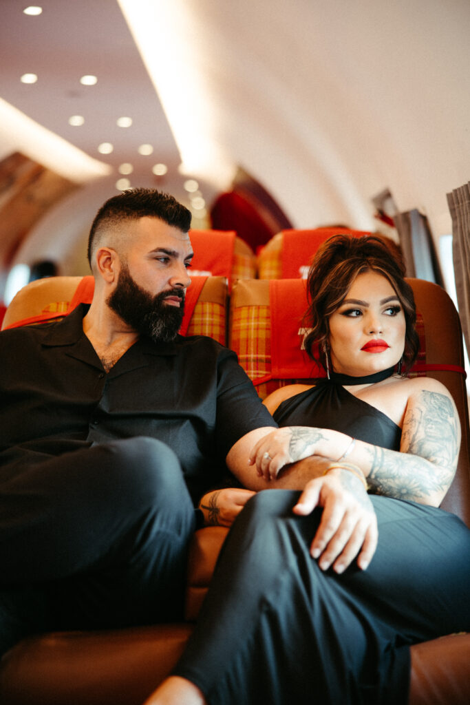 Couple enjoying a quiet, intimate moment in the cozy seating area of the TWA airplane lounge."