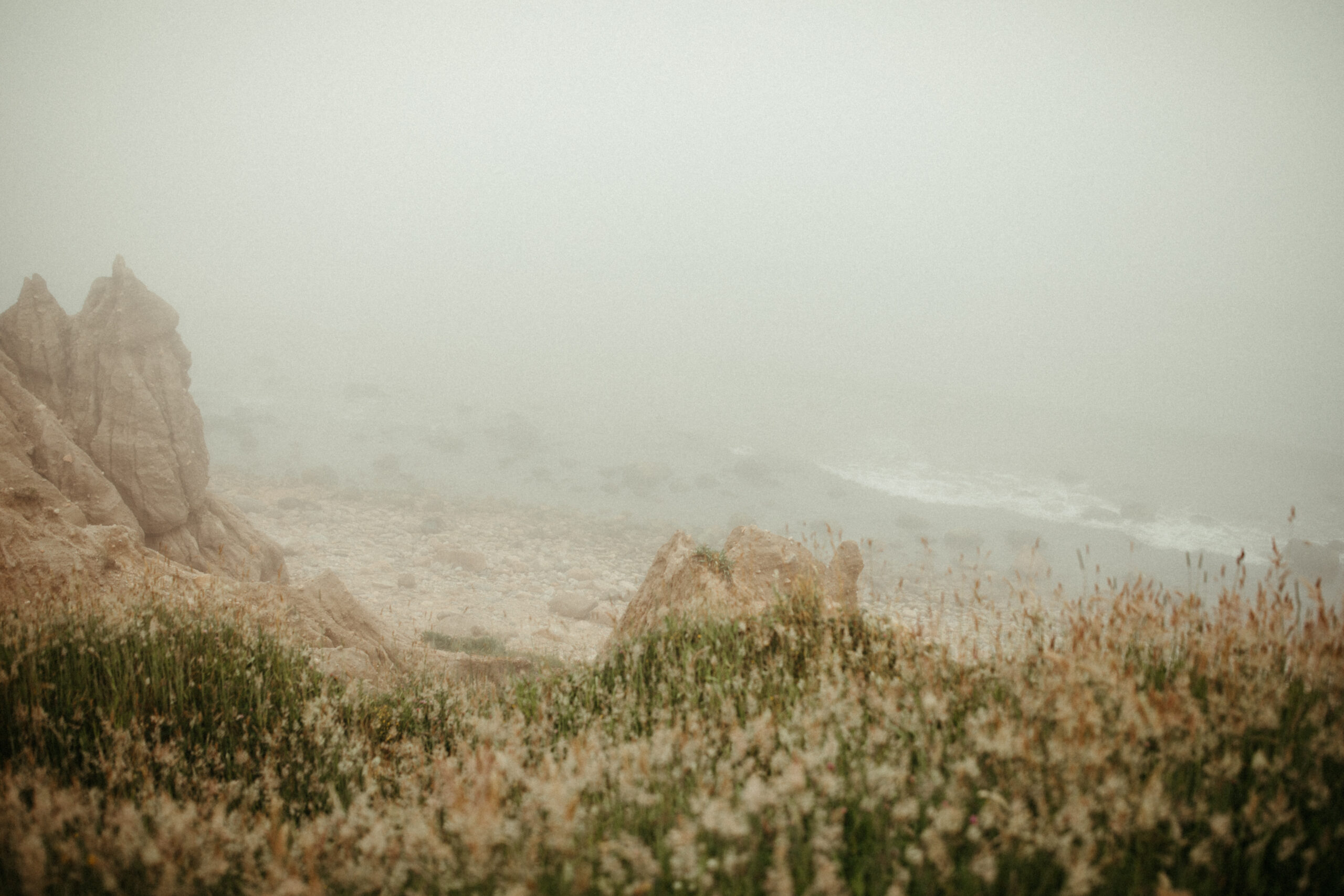 A grainy, film-like shot captures a faint glimpse of the water below.