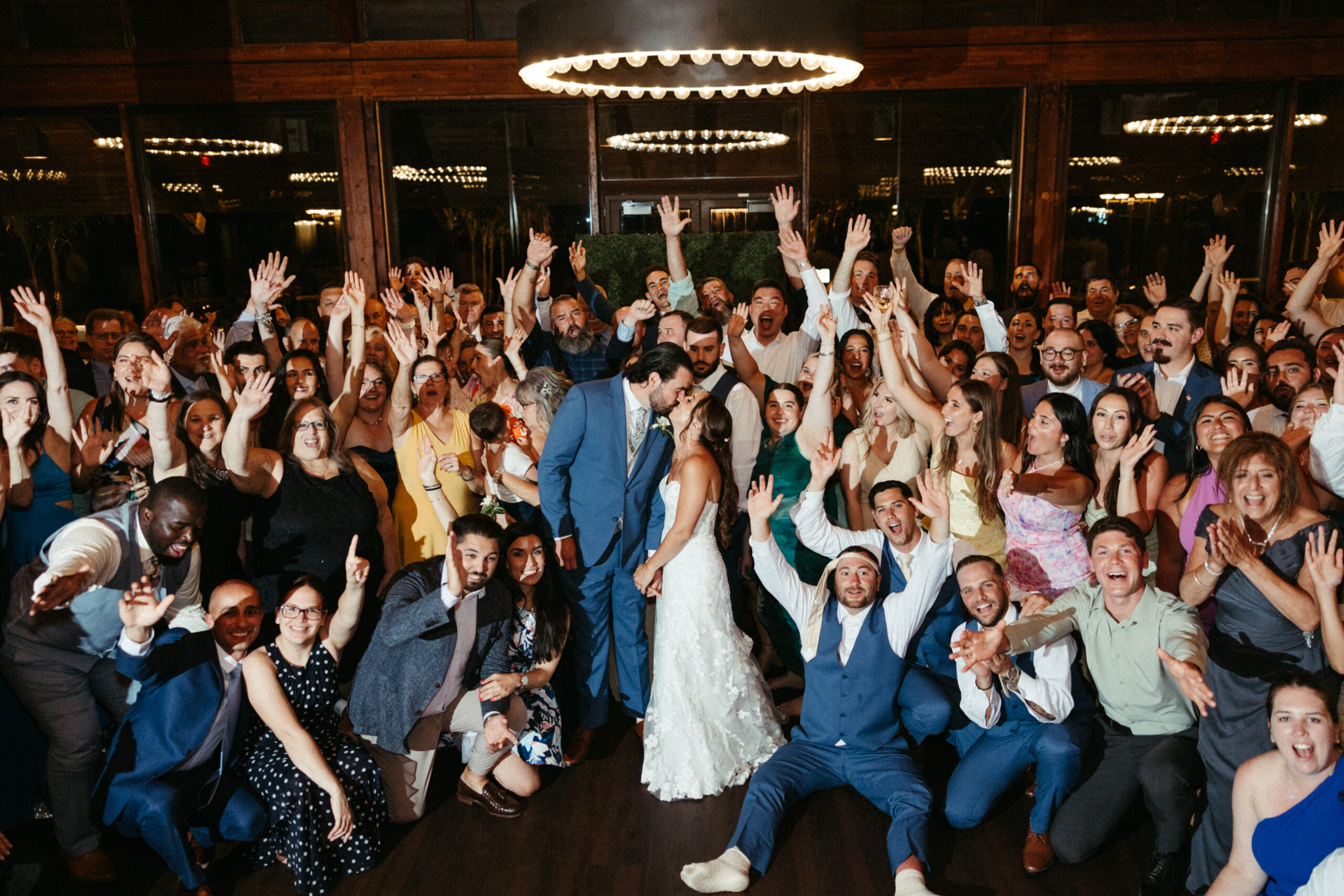 Guest surround the couple on the dance floor.