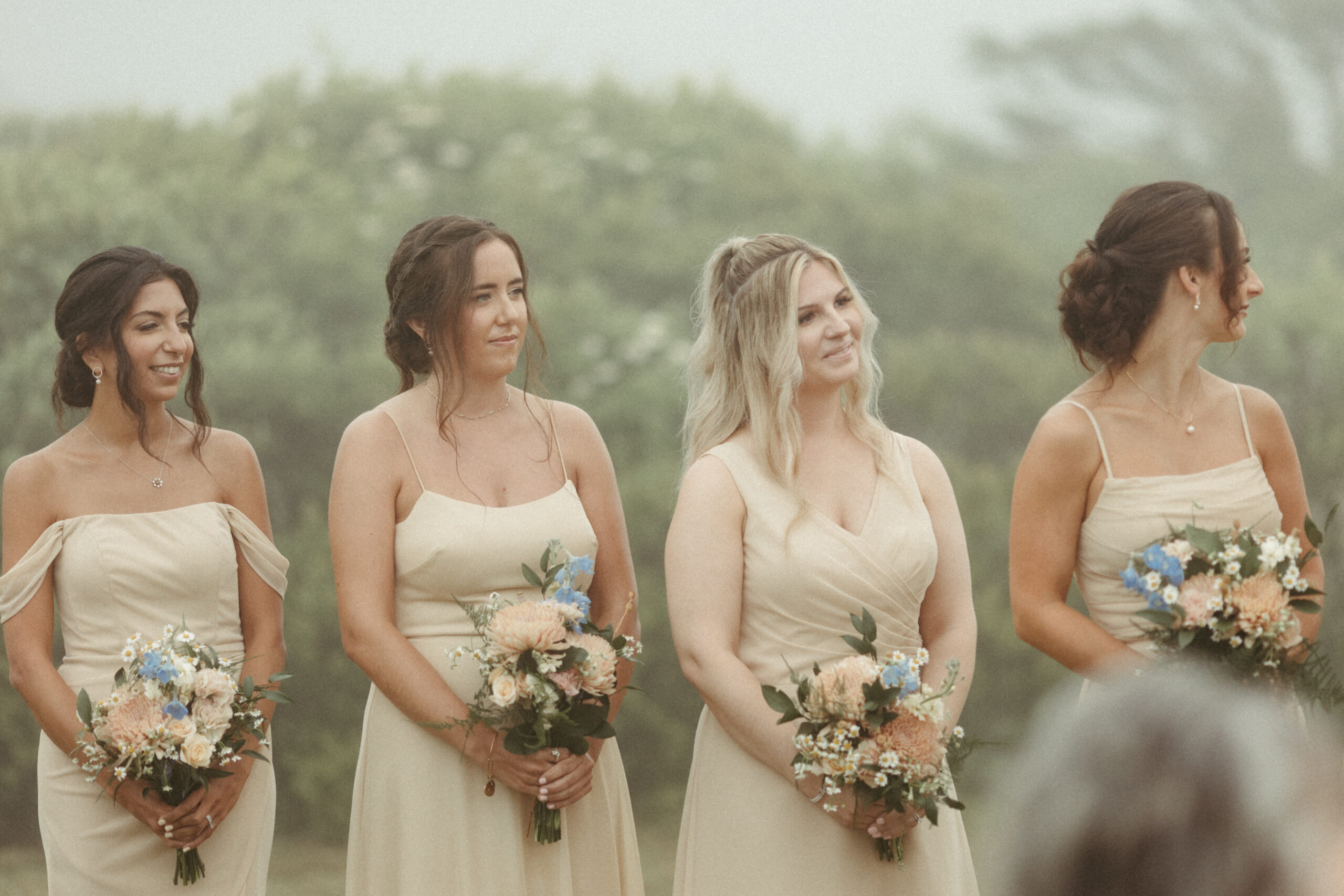 Bridemiads look on as their friends exchange vows. 