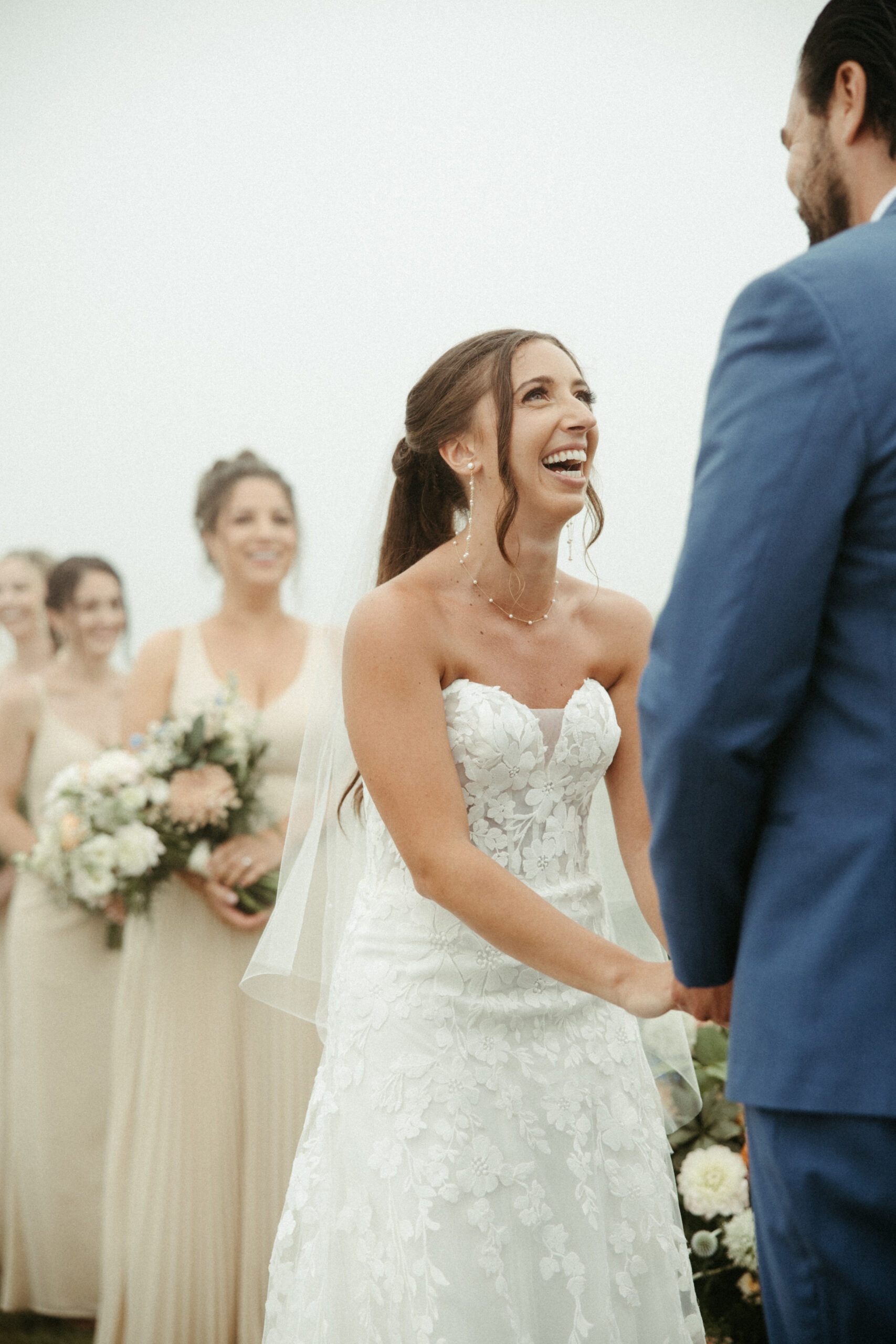 Bride laughs during a wedding ceremony.