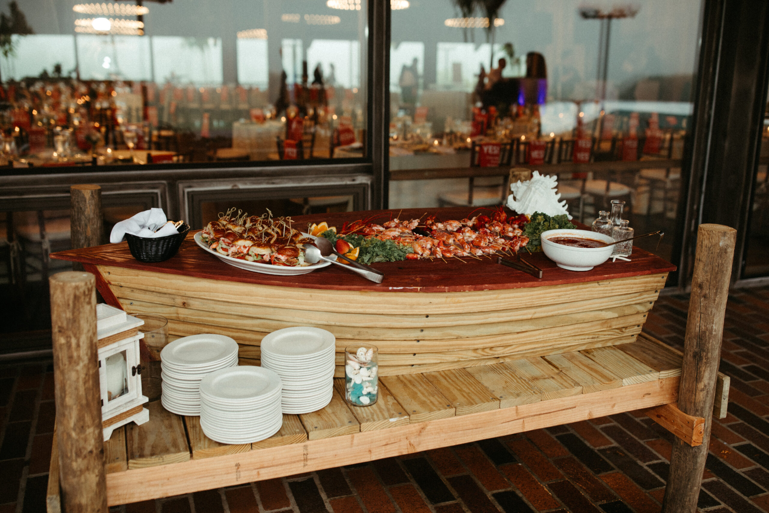 A lavish seafood display at cocktail hour, with oysters, lobster tails, and fresh shrimp on ice.