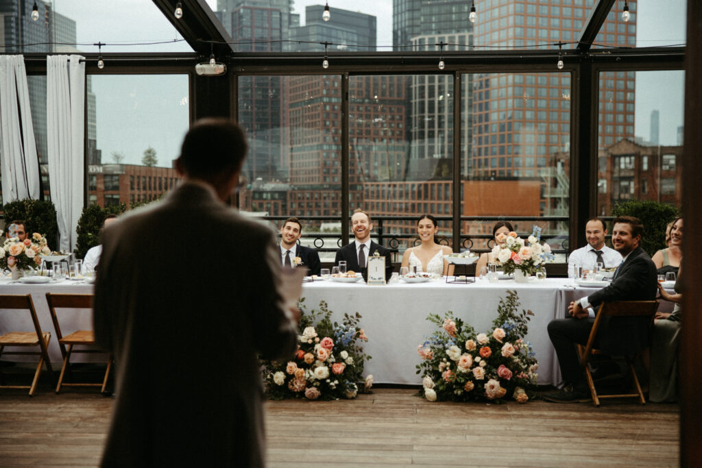  A newly wed couple shares a laugh during the toasts on their wedding day.