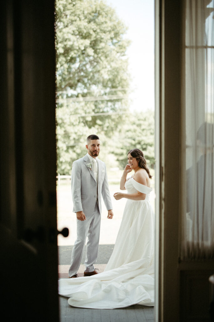 A couple sharing a laugh during there portraits on their wedding day.