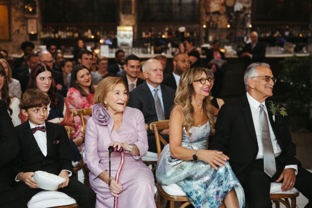 Wedding guests smiling and reacting emotionally during Adrianna and Jack’s Houston Hall ceremony in New York City