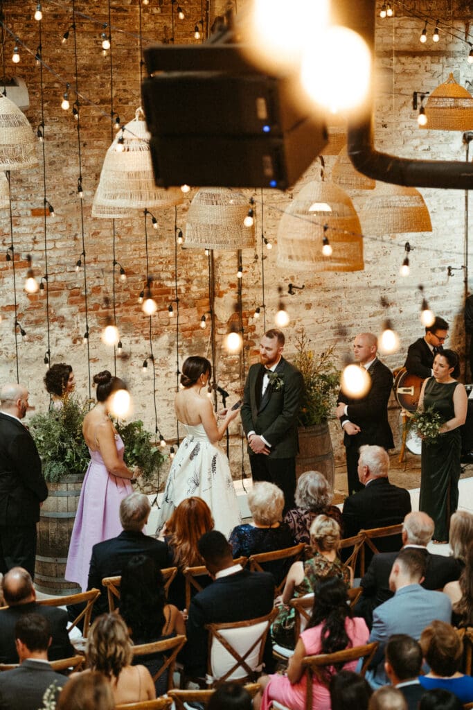 Emotional close-up of Adrianna and Jack holding hands during their wedding vows at Houston Hall in New York City