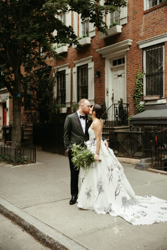Bride and groom sharing a quiet kiss on a West Village street during their Houston Hall wedding in New York City