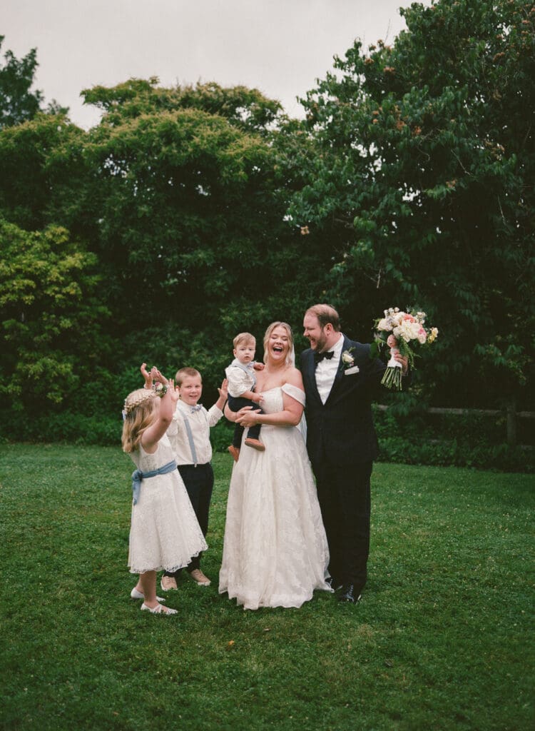 Bride and groom celebrating with children and family during Stone Acres Farm wedding in Stonington Connecticut