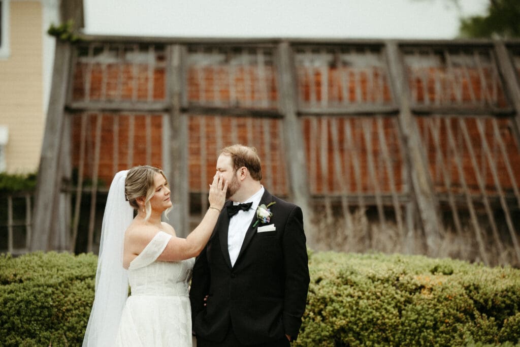 Bride touching groom’s face during romantic portrait at Stone Acres Farm wedding in Connecticut