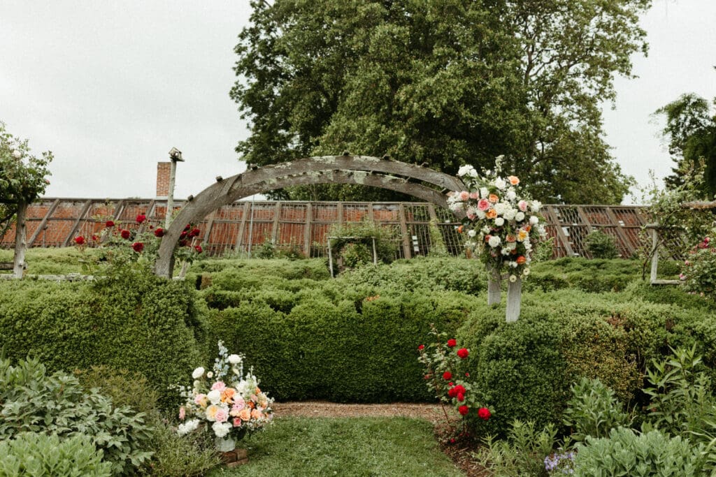 Garden arbor covered in roses and wedding florals at Stone Acres Farm, a romantic ceremony setting for a Stone Acres Farm wedding in Connecticut